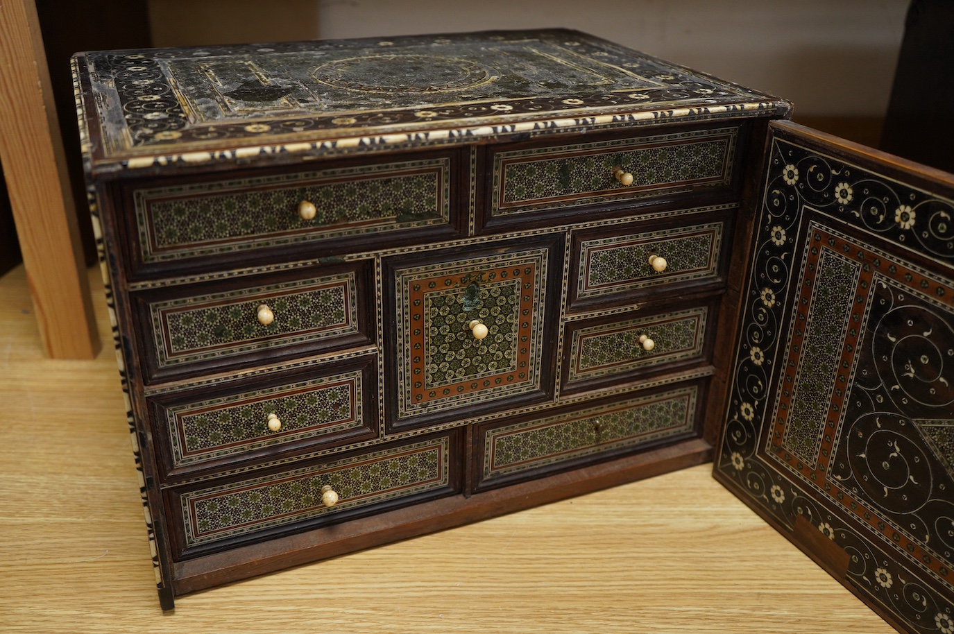 An early 17th century Indo-Portuguese ivory inlaid table cabinet, Gujarat, 29cm high. Condition - poor, losses CITES Submission reference 3XBFQXPT